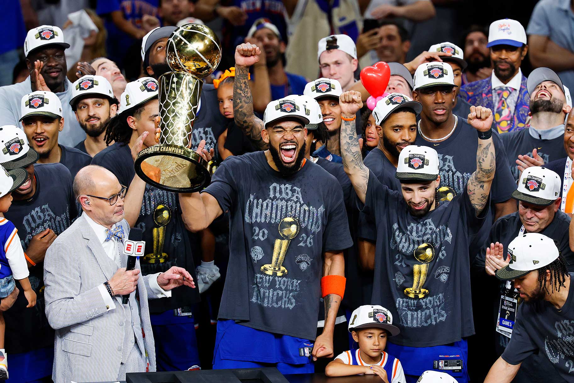 Karl-Anthony Towns of the New York Knicks cheering and celebrating with the Larry O'Brien Championship Trophy after the victory against the San Antonio Spurs in Game Five of the 2026 NBA Finals.