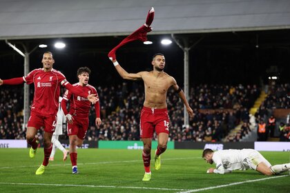 Cody Gakpo of Liverpool celebrates scoring his team's second goal with teammates Virgil van Dijk and Milos Kerkez.