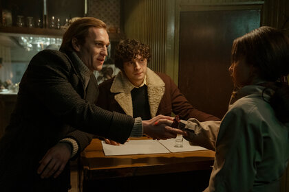 Andrei, Sasha, and Bea talking across a table in PONIES Season 1 Episode 1.