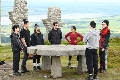 Eric Nam, Colton Underwood, Mark Ballas, Stephen Colletti, Natalie Anderson, Rob Rausch, and Alan Cumming talking in The Traitors Season 4 Episode 7.