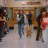 John (Max Burkholder) and Ted (Seth MacFarlane) running down a school hallway in Ted Season 2.