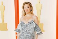 Kate Hudson in a silver dress while posing at the 95th Annual Academy Awards.